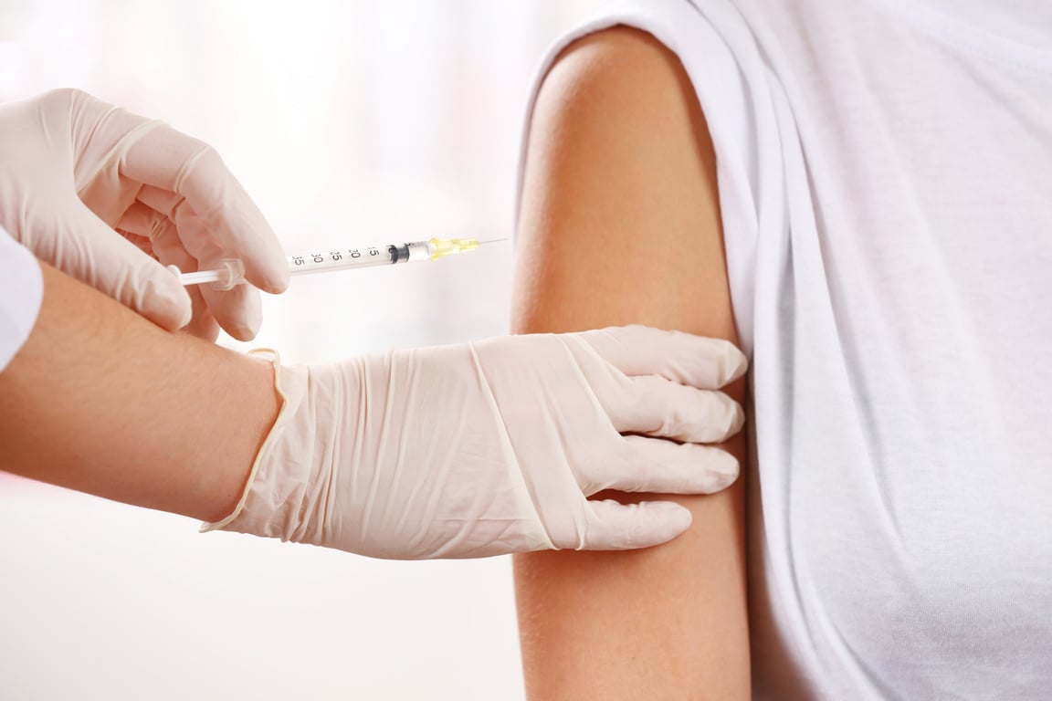 Medical Worker Injecting a Woman's Arm Up Close 